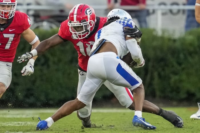 Georgia Bulldogs defensive back Lewis Cine (16) tackles Kentucky receiver Wan'Dale Robinson (1). Mandatory Credit: Dale Zanine-USA TODAY Sports